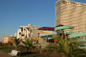 a large building with a water slide in front of it at Family Apartment in Batumi