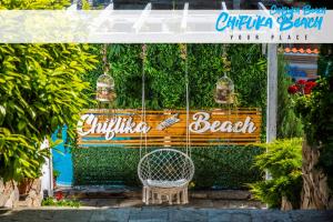 a swinging chair in front of a bench at Chiflika Family Hotel in Asenovgrad