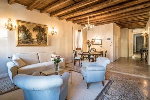 a living room with a couch and a table at Palazzo Veneziano direct at the canal with roof terrace in Venice
