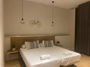 a bedroom with a bed with a bike on the wall at Lullaby by hamilton in Barcelona