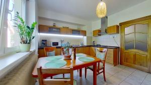 a kitchen with a table and chairs and a dining room at Ron De Mar #3 modern room in Pezinok