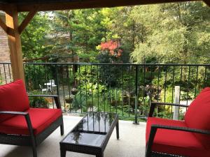 a porch with two chairs and a coffee table on a balcony at Hammer Haus in Waterloo