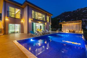 a house with a swimming pool in front of a house at LA VILLA CELINE- Luxury Sea View Villa with Private Infinity Pool in Islamlar-Kalkan in Kalkan