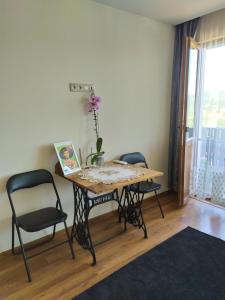 una mesa con dos sillas y una mesa con una flor. en Stefi house en Veliko Tŭrnovo