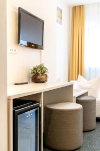 TV a/nebo společenská místnost v ubytování Hotel Wandinger Hof by Lehmann Hotels