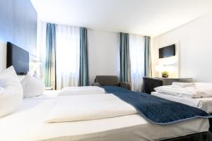 Postel nebo postele na pokoji v ubytování Hotel Wandinger Hof by Lehmann Hotels