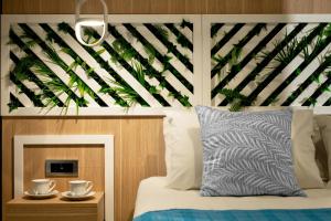 een slaapkamer met een bed met een groot houten hoofdeinde bij Villa Elite "by Checkin" Adults Only in Chersonissos
