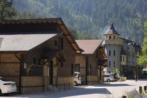 a large wooden building with a tower on a street at Horlog Castle in Trigrad