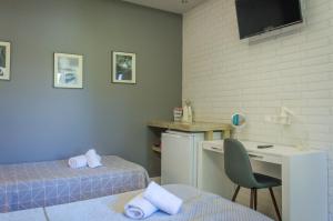 a room with two beds and a desk and a chair at Villa Eden in Limenas