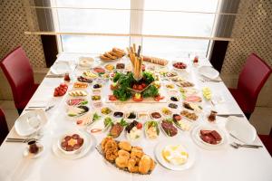 a table with plates of food on it at Afyon Orucoglu Thermal Resort in Afyon