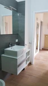 a bathroom with a white sink and a mirror at Arco Home in Arco +15 photos