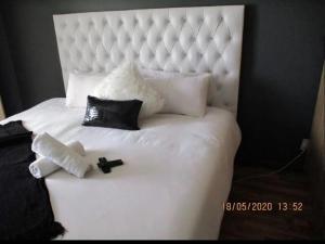 Ένα ή περισσότερα κρεβάτια σε δωμάτιο στο Imimangaliso Guest House