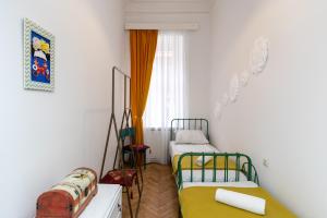 a small room with two beds and a window at ❁ Casa Frida ❁ Exceptional Stay In Old Town! ❁ in Tbilisi City