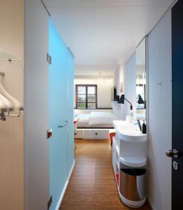 a bathroom with a sink, toilet and bathtub at citizenM Geneva in Geneva