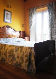 a bedroom with a large bed with a large window at Bed & Breakfast Margherita in Bologna