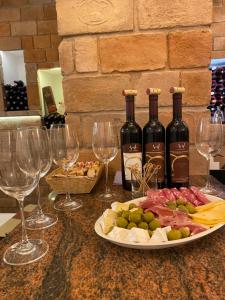 a table with wine glasses and a plate of food at Apartmán Schindlerka in Banská Štiavnica
