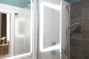 a shower with a glass door in a bathroom at Pension Moselvilla 1900 in Cochem