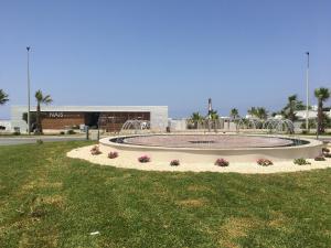 a large fountain in the middle of a field of grass at La Casa Degli Agrumi in Trapani