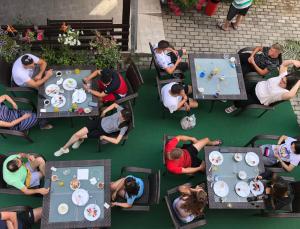 a group of people sitting at a table eating food at Villa Milka in Ohrid