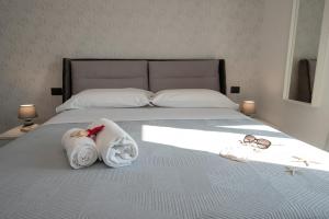 Posteľ alebo postele v izbe v ubytovaní LA DOLCE VITA ROOMS