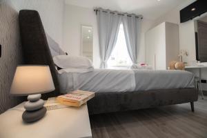 Posteľ alebo postele v izbe v ubytovaní LA DOLCE VITA ROOMS