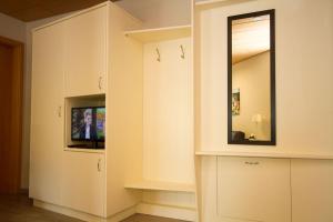sala de estar con TV y espejo en Gästehaus Trostelhof, en Salem
