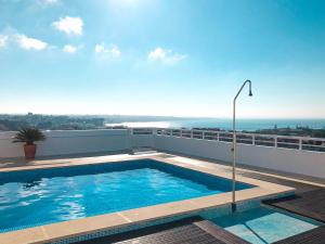 a swimming pool on the roof of a building at Seguros House - Charming Flat in Cascais