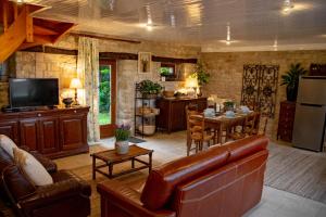 a living room with a couch and a table at Holiday home Haras du Ry in Brévands