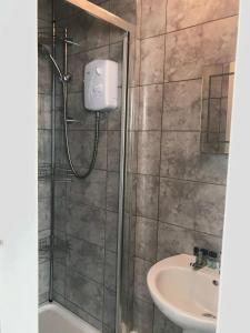 a bathroom with a shower and a sink at The Southwold Guest House in Skegness