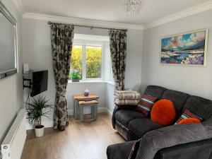 a living room with a couch and a window at Two Bedroom Town House Beside The River Barrow in Carlow