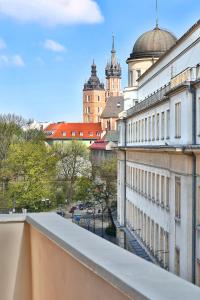 a view of a city from the balcony of a building at Hotel Wielopole in Krakow