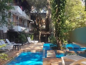 a swimming pool with blue water in a building at Kelta Hotel Puerto Iguazú CENTRO in Puerto Iguazú