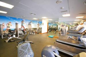 a gym with tread machines and a mural on the wall at Downtown Cozy Home + partitioned living room in Dubai
