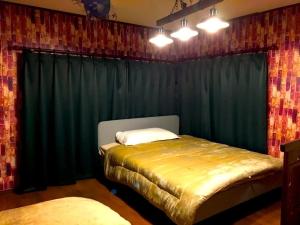 a bedroom with two beds in front of a curtain at THE HIGHEST VILLA IZUMI - Vacation STAY 07935v in Nakatsugawa