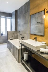 a large bathroom with a tub and a sink at Apartments Dolac in Rijeka