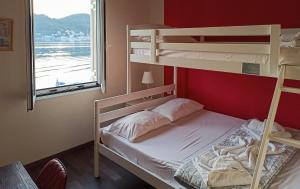 a bedroom with two bunk beds and a window at ORION (ΩΡΙΩΝ) in Vathi