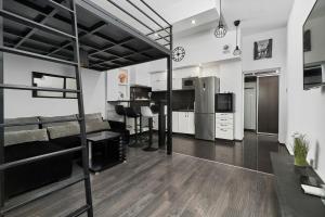 a living room with a bunk bed and a kitchen at Apartments Wrocław Ruska by Renters in Wrocław