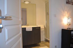 a bathroom with a sink and a mirror at Hôtel de La Croix de Malte in Cherbourg en Cotentin +28 photos