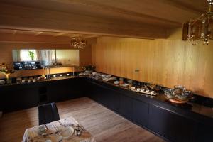 a large kitchen with a table in the middle at Pension Pernthaler in Silandro +30 photos
