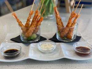 a tray with three containers of food with dipping sauces at Pensión Venus in Nigrán