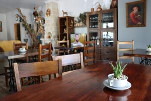 a dining room with a wooden table and chairs at Quinta Ribeiro Tanquinhos in Tancos