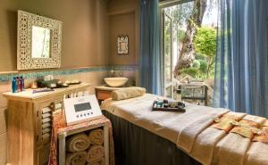 a massage room with a sink and a bed at Columbia Beach Resort in Pissouri