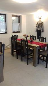 a dining room with a table with chairs at Casa Radu Novaci in Novaci-Străini