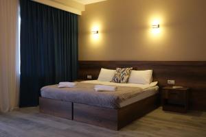 a bedroom with a bed with two towels on it at Hotel Axien Kazbegi in Kazbegi