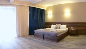 A bed or beds in a room at Hotel Axien Kazbegi