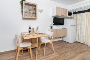 a small kitchen with a table and chairs and a refrigerator at Vista Bonita in Benalmádena