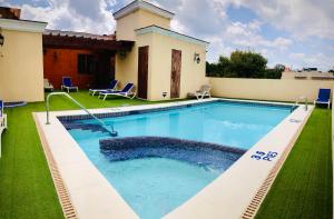 a swimming pool in the yard of a house at Boutique Hotel Palacio in Santo Domingo