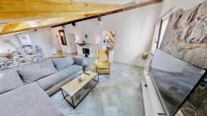ein Wohnzimmer mit einem Sofa und einem TV in der Unterkunft Appartamento San Michele in Triest