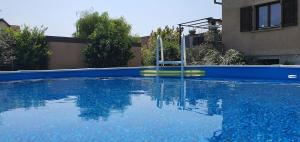 a swimming pool with a slide in the water at Maison de vacances piscine proche Strasbourg et Europa park in Sand