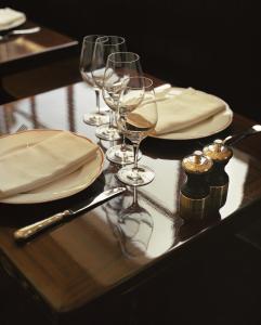 a wooden table with wine glasses and napkins on it at Ch&acirc;teau Voltaire in Paris